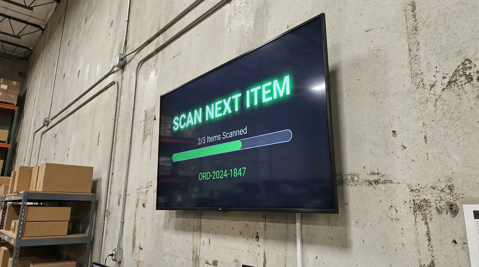 Warehouse TV display showing packing interface
